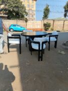 4-Seater Black Marble-Finish Oval Mahogany Dining Set with Cream Chairs